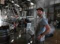 Grant Smith (left background) and Andrew Newton from Two Mates Brewing in South Lismore, cleaning up after the flood on February 28. Picture: Cathy Adams