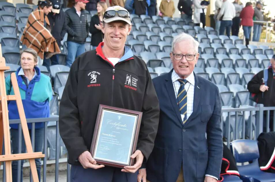 Peter Haynes was presented with a certificate of appreciation by president David Clifton for his dedication to New England Rugby Union. Picture by Ellen Dunger