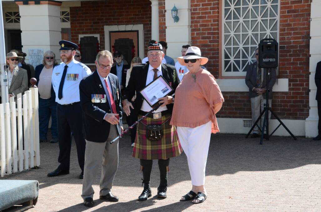 Tenterfield RSL sub-Branch president, Major Dave Stewart (Rtd), presents Harry and Shauna Bolton with a Certificate of Appreciation for their contributions to the Tenterfield Highlanders Pipe Band. Pictures supplied