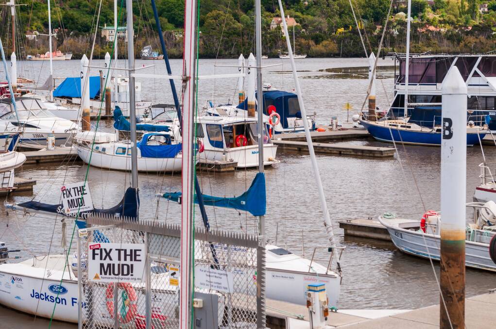 "Fix the Mud" signs are a common sight in Launceston, particularly at the marina where boats can't exit at low tide. Picture: Phillip Biggs