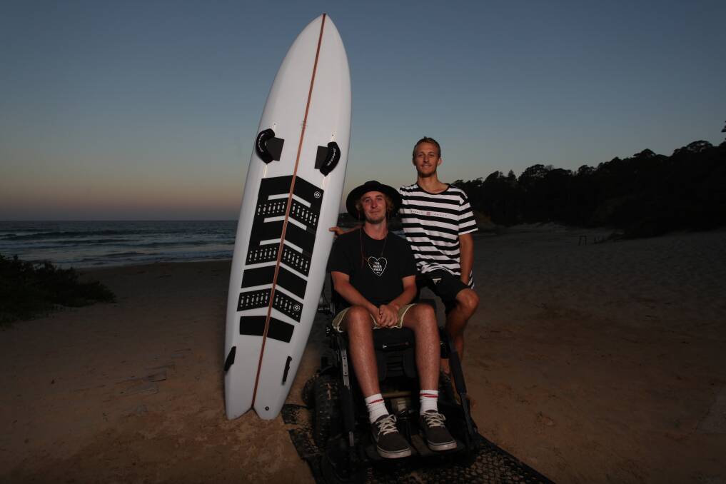 New board: Jason Apps pictured with his brother and carer Will Apps at Tathra Beach. Picture: Rachel Mounsey.