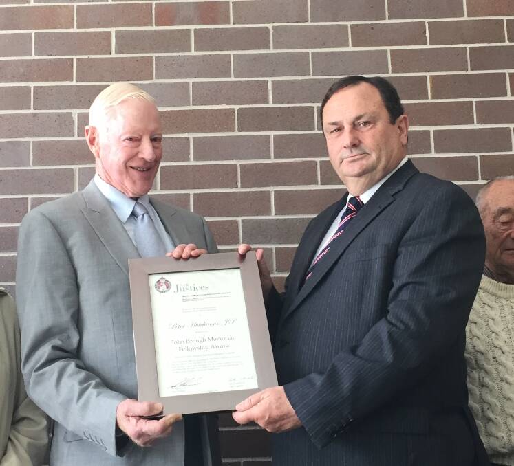Top honour: Magistrate Michael Holmes presents Peter Hutchinson with the John Brough Fellowship Award at a ceremony in the Armidale Courthouse.