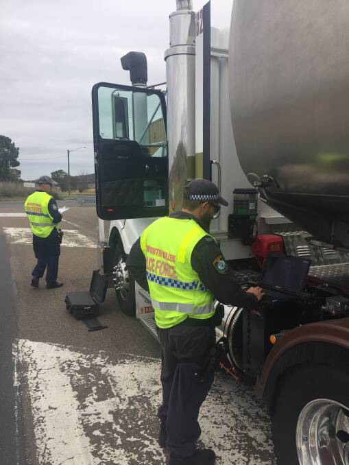 Cop crackdown: Specialist heavy vehicle police from the Joint Traffic Taskforce backed local highway officers to inspect trucks at Kankool on Wednesday.