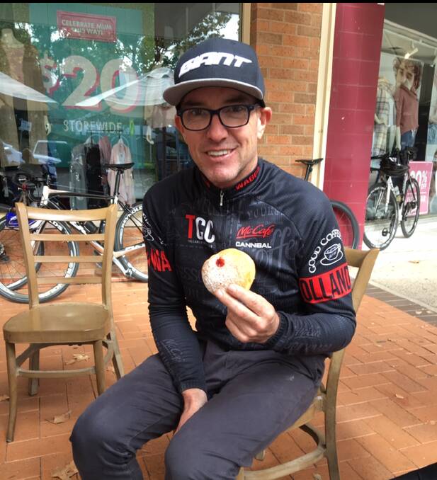 Andrew Bradley eating a donut post race.