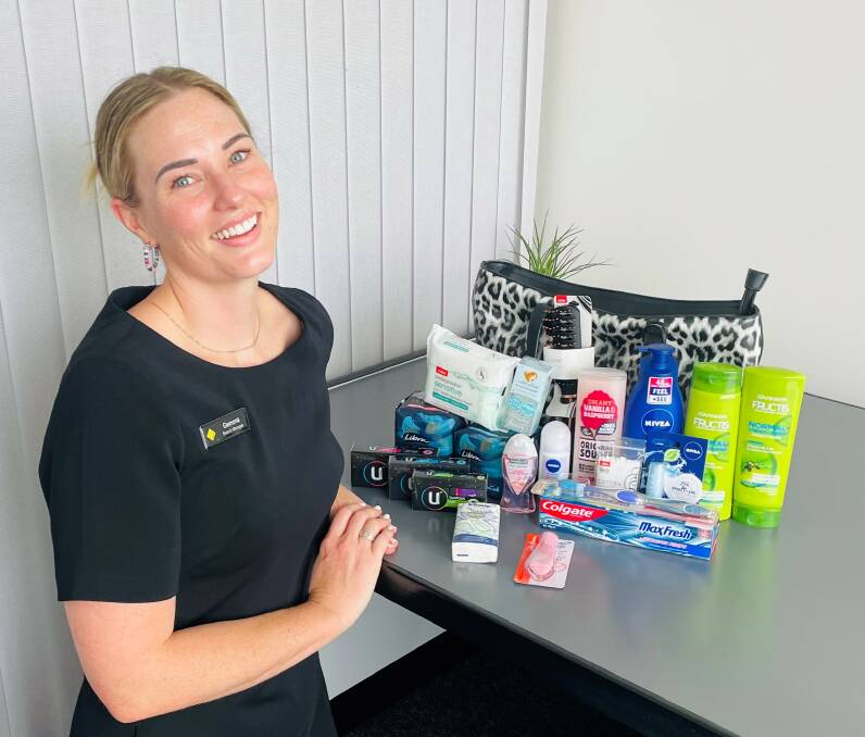 SHARE THE DIGNITY: Commonwealth Bank Tenterfield branch manager Gemma Taylor with one of the bags and donated items. Picture: SUPPLIED