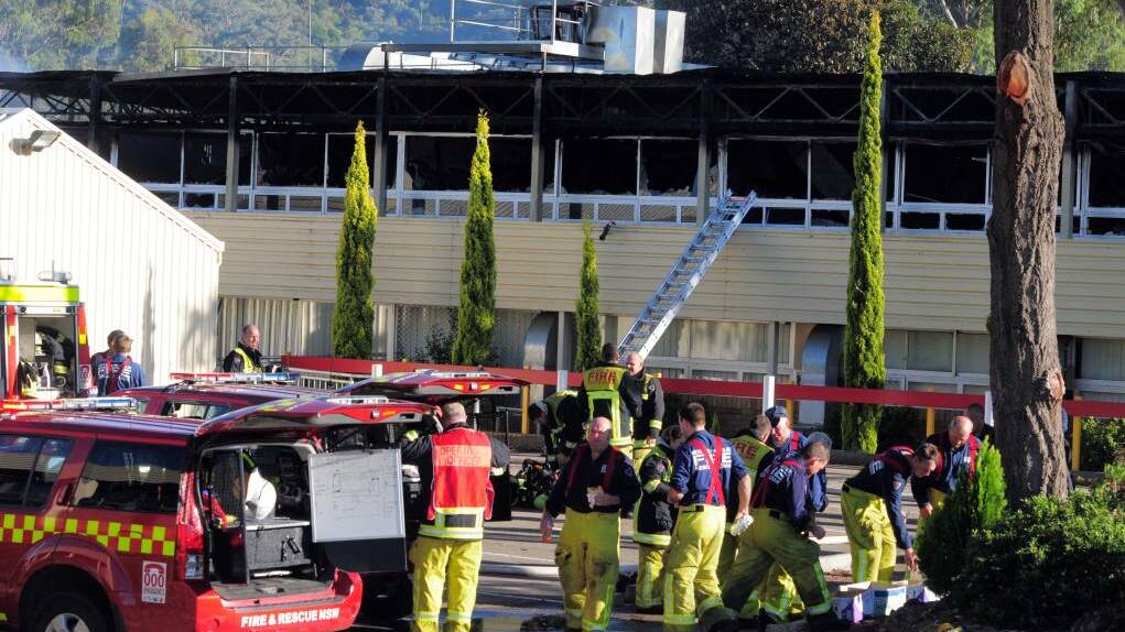 DELIBERATELY LIT: Firefighters at the scene of the blaze on March 18, 2012, at Oxley High School which left a damage bill of $12 million. Photo: Robert Chappel