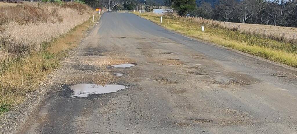 A damaged road with potholes in Tenterfield. 