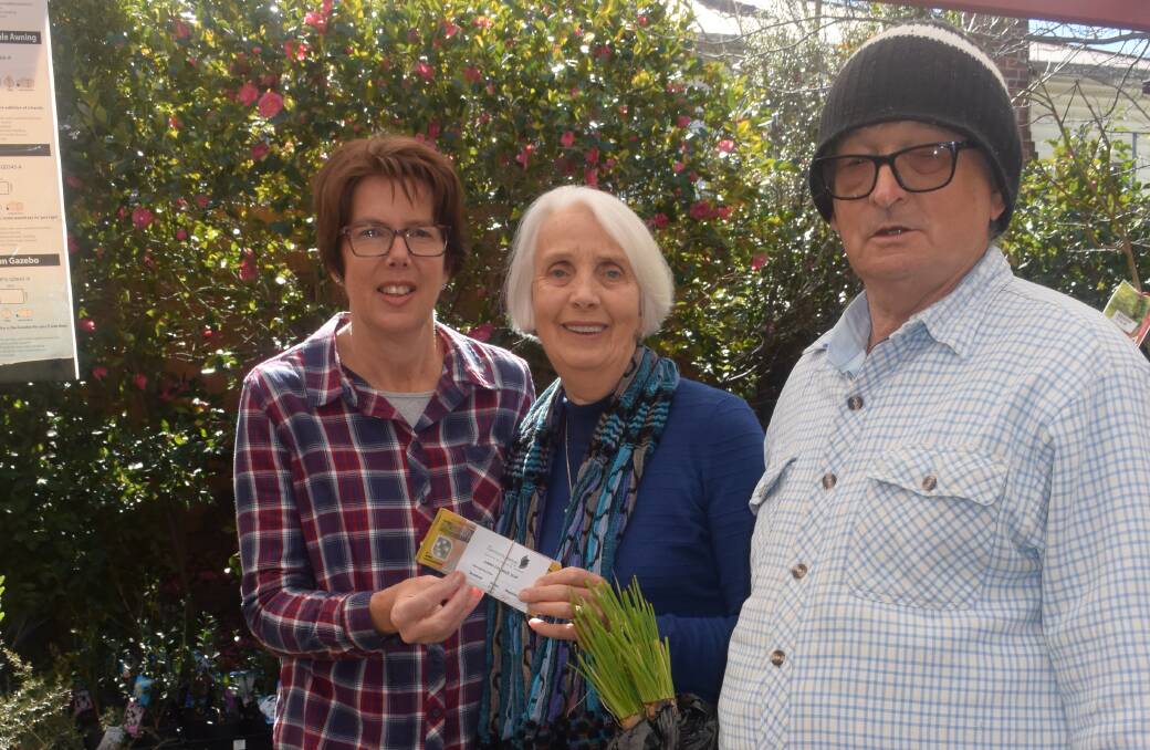 Thrifty-Link Hardware's Linda Nye hands over the proceeds to date to Tenterfield Care Committee's Rhonda Rovera, generated by sales of John Flint's onion seedlings.