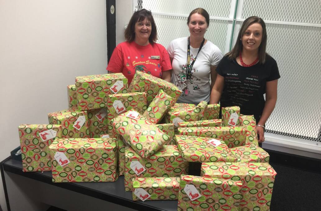 Commonwealth Bank staff Debbie Minns, Megan Watters and Mandie Ramma with the mountain of gifts for local families.