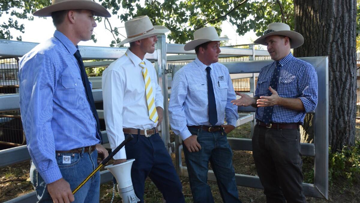 Young auctioneers Tom Jarrett (first), Ben Johnston (second) and Jack Maloney (third) get some advice from judge Allistair Rayner. 