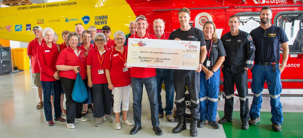 John 'Dodge' Landers and the Tenterfield Volunteer Support present a donation to the crew of the Westpac Life Saver Rescue Helicopter.