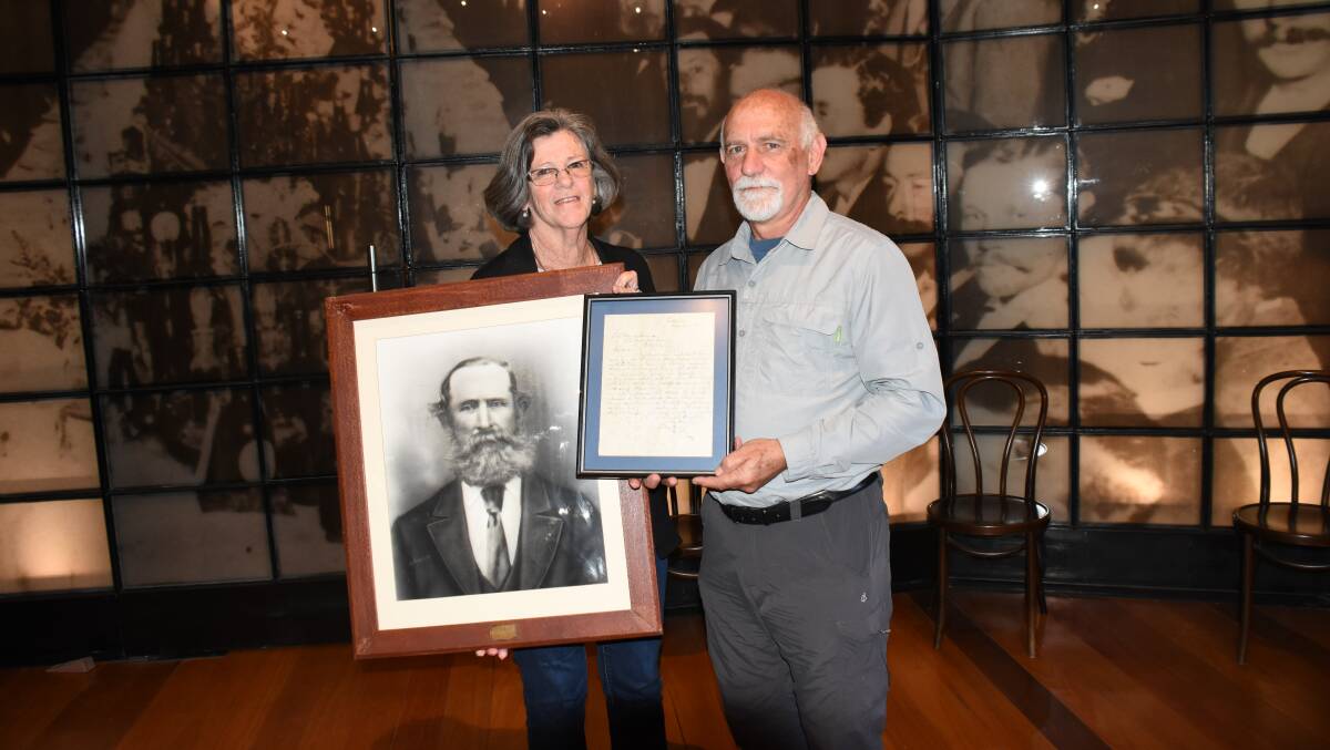 Linda and Peter Kerslake with a portrait of Thomas Wellburn, Tenterfield's first mayor, and the letter Peter found in a glove box at Glen Innes tip more than 30 years ago.