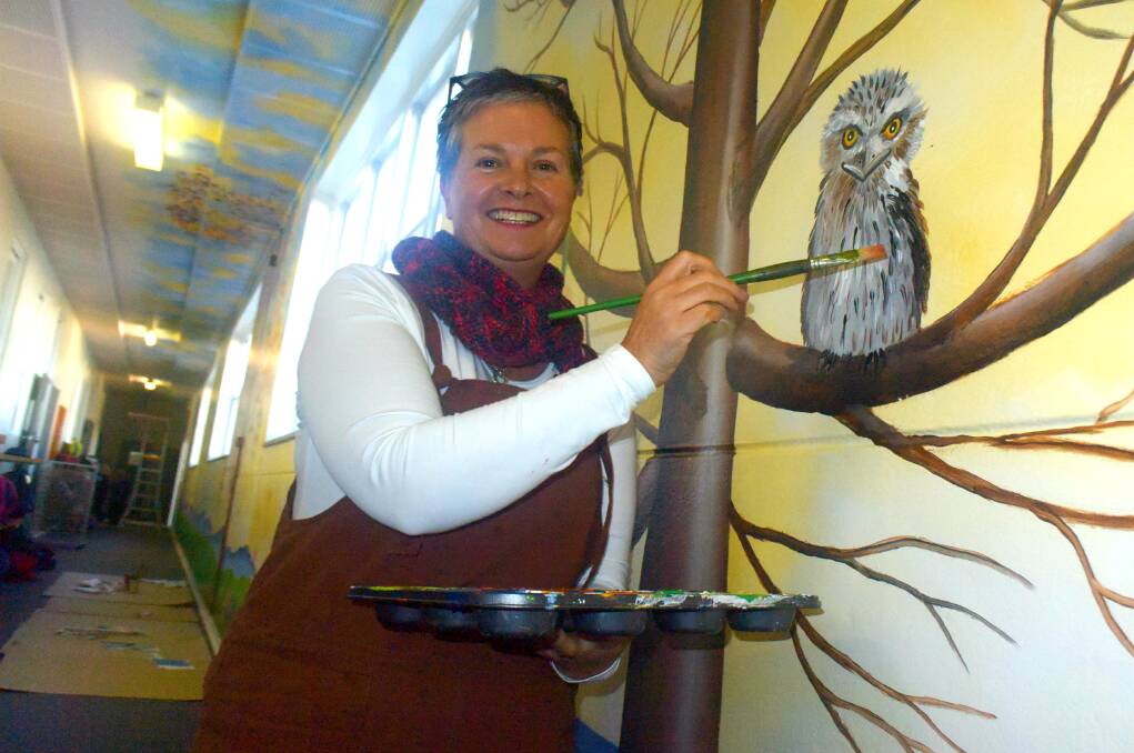Samantha Wortelhock has transformed 40 schools with her engaging murals, cosying up here to a tawny frogmouth in Tenterfield.