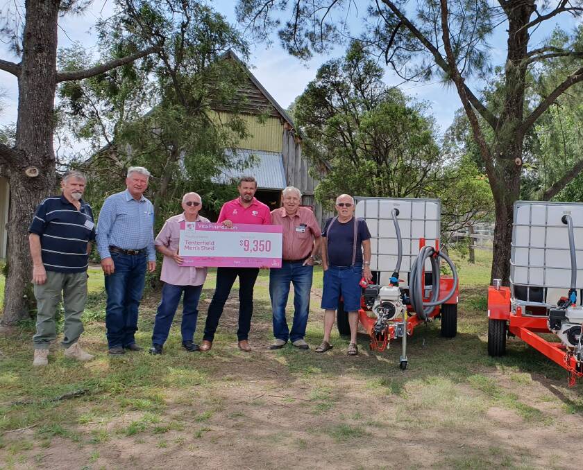 Water on the move: (From left) Edy Vas, Mayor Peter Petty, Peter Chittick, Vita's Paul Edmonson, Rex Holley and Ted Hartfield at the Tenterfield Men's Shed for the handover of the water trailers on Monday.