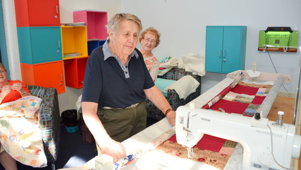 Fay Mills works on the quilting frame as Barbara Crowley looks on during last year's Quiltathon.