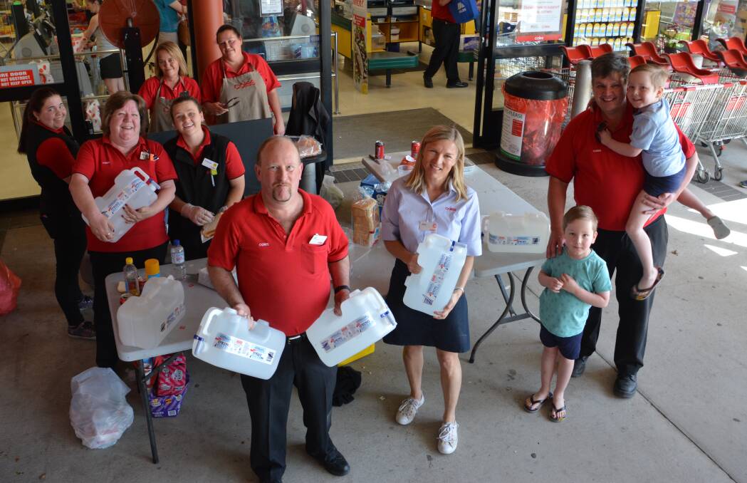 Coles Tenterfield's Lee Harley with Julie Balderstone, head of community and stakeholder engagement, store manager Kyle Swift (and sons Campbell and George) and more of the Tenterfield crew who helped in Sunday's water distribution. Photo by Melinda Campbell.