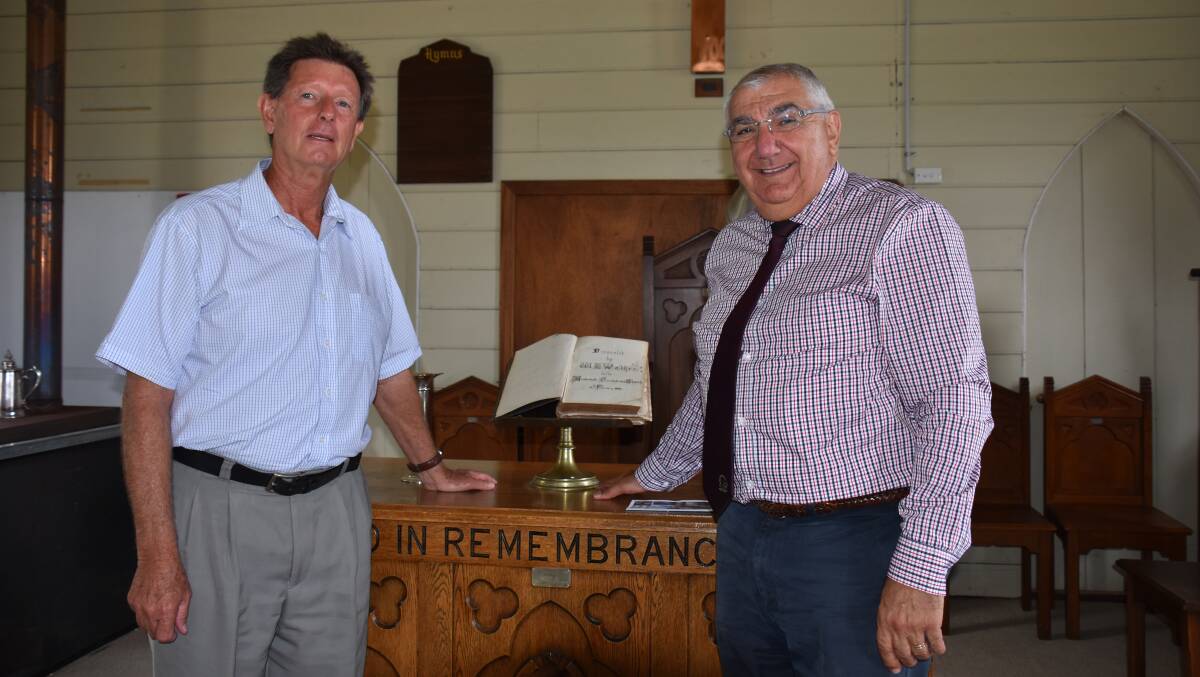 Pastor Jim Seymour and MP Thomas George with the bible donated to the church by Tenterfield Station's WH Walker.