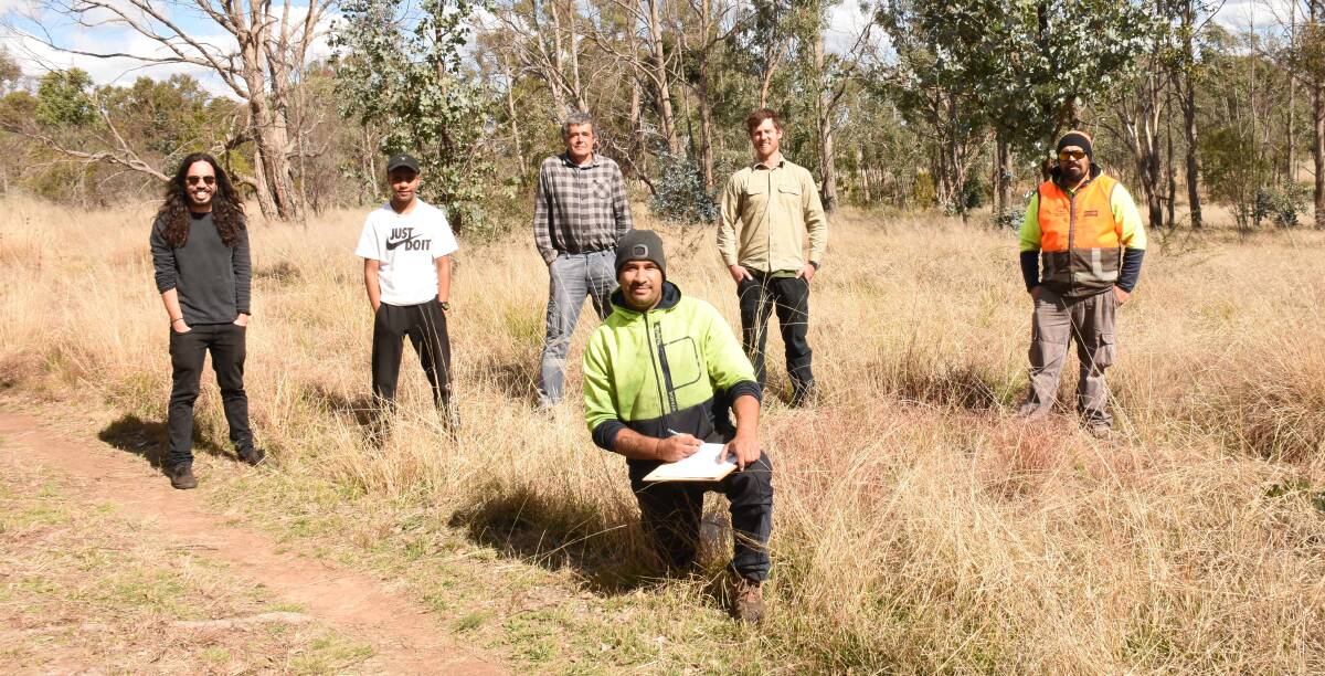 Traditional approach: (From left) Moonbahlene's Matt Sing, Michael Nicholls and Mick Badham joined Tamworth LALC's Sam Des Forges and Banbai rangers Dominic Cutmore and (kneeling) Tremane Patterson to plan out next week's cultural burn at Tenterfield Park. Photo: Donna Ward.