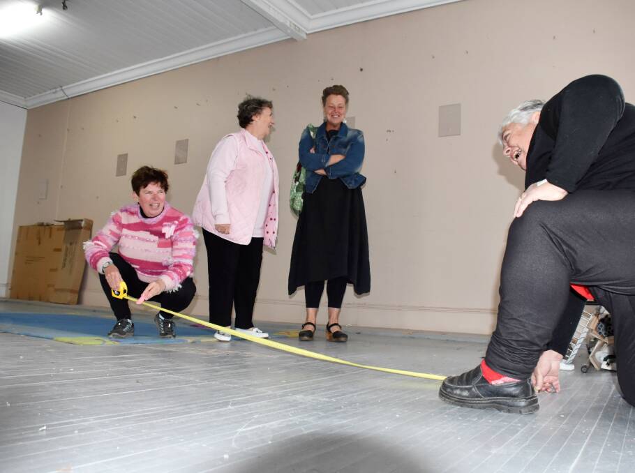Measuring up: Ruth Rutherford and Nanette Watts allocate stand space on the upper floor of Mitre 10 as Make It Tenterfield secretary Carmel Higgins and president Helen Worland look on.