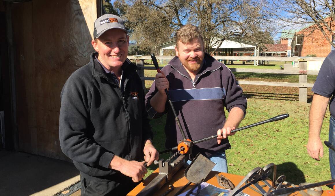 Greg Cowie and Matthew Coker get in a twist with the Metalcraft tools being demonstrated to students and Mens Shed members.