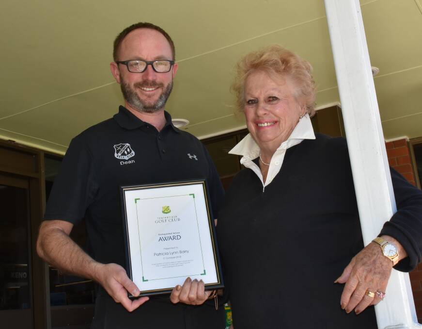 Tenterfield Golf Club manager Dean Hines and award recipient Patsy Barry following her two decades of dedication to junior golf.