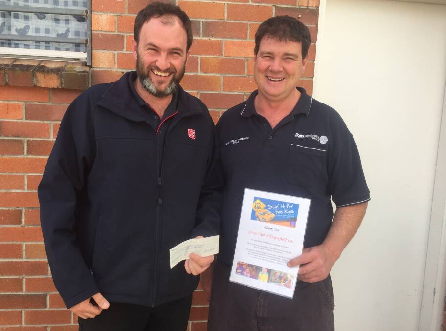 Joel Soper of the Tenterfield Salvation Army gratefully accepts the donation from Lions Club of Tenterfield President Stephen Whiticker, thanks to support from Trek4Kidz.