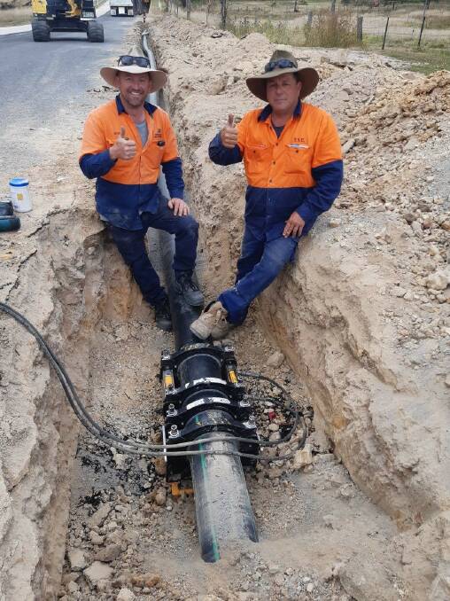 Contractor Mark ONeill and council's services operator Aaron Long give a thumbs-up to completion of the bore system pipework.