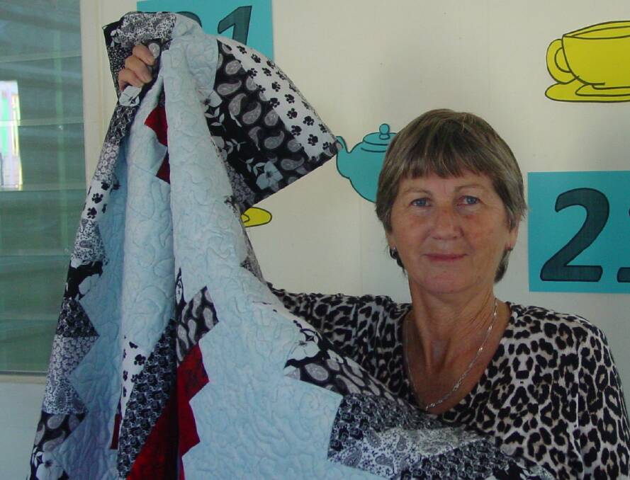 Eliza Petty is the winner of the beautiful handcrafted quilt kindly made and donated by Joan Reid. Photo by Joyce Marsh.