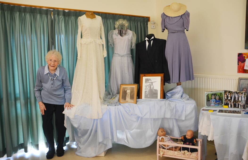 Joyce Butler with her 1948 wedding dress, the bridesmaid's dress she wore to her brother John's earlier wedding, and the purple dress on the right was her going-away outfit for a honeymoon down the coast.