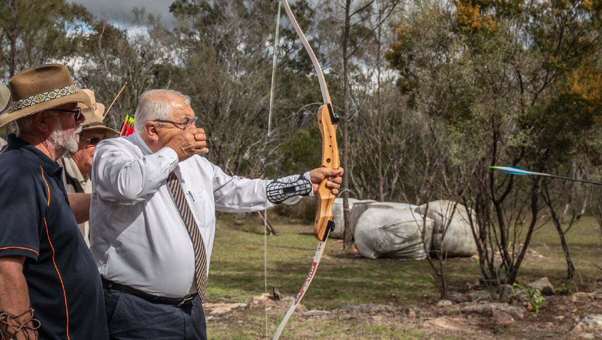 MP Thomas George shoots his first arrow at the Tenterfield Traditional Archers site which will now have a new shelter thanks to a Stronger Country Communities Fund grant. Photo by Peter Reid.