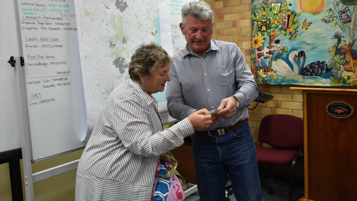 Who needs glasses then? Mayor Peter Petty drew the winning names, but needed Carmel Higgins to check the ticket.