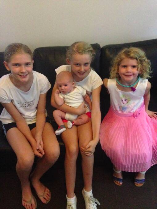 Jess, Emma (holding Will) and Holly welcome their new baby brother to the Petrie family.