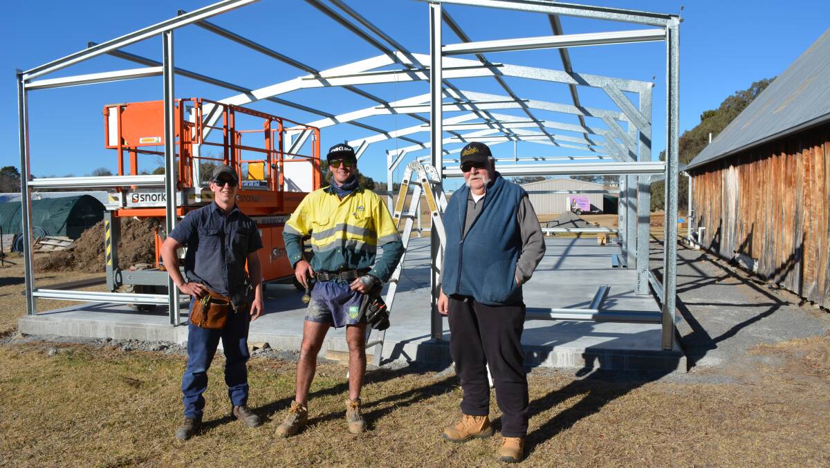 James Hagley, Luke Clare and Tenterfield Men's Shed's Ian Docherty when the frame of the new shed went up.