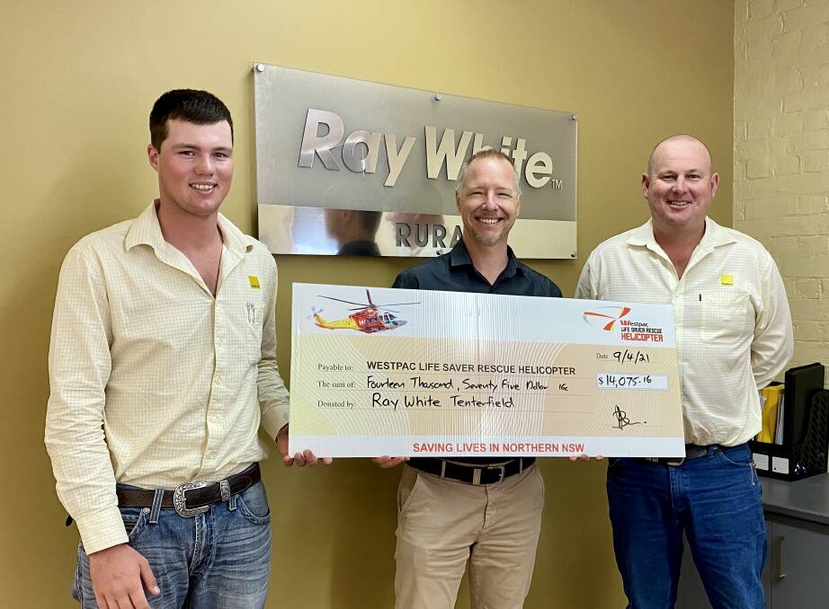 Westpac Life Saver Rescue Helicopter's Zeke Huish (centre) happily accepts from the donation from Ray White Tenterfield's Jake Smith and Ben Sharpe.