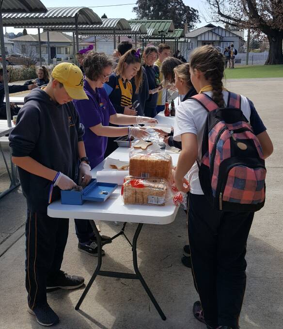 Students line up for the sausage sizzle.