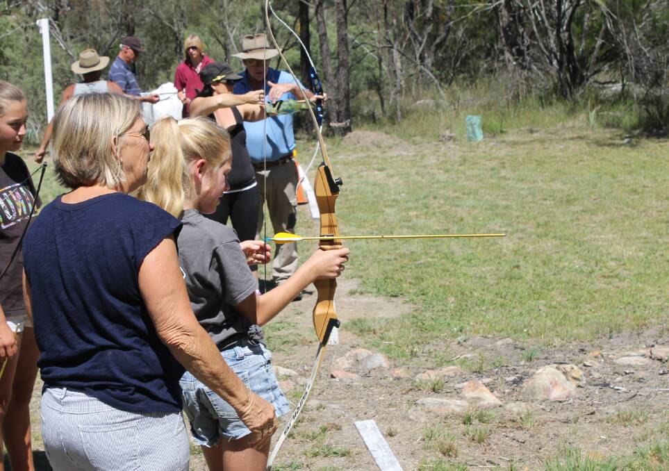 Marian Rogan gives young archer Elsie Cross some tips on the practice range. Juniors are being encouraged to represent the club at the National Muster in October.