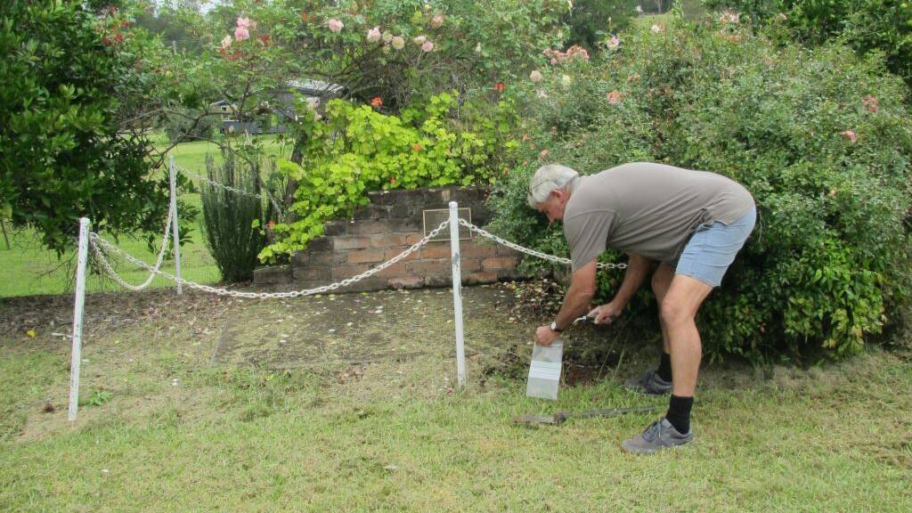Ray Holmes collects a soil sample for the centenary project from Drake Hall.