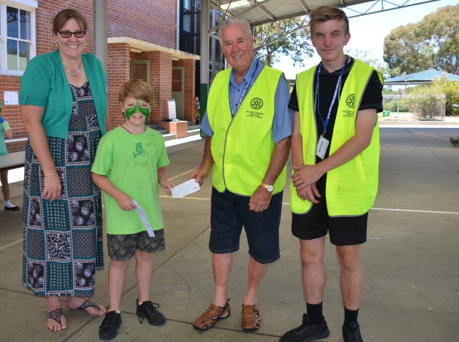 Teacher Tracy Caldwell and Belonging Day organiser Archie George receive the generous donation from Rotary representatives Aaron Blacker and Ralph Manser.