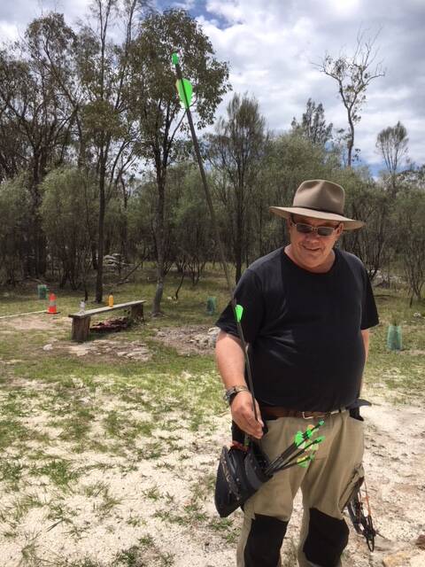 Tenterfield Traditional Archers' Wayne Trenning achieves a Robin Hood shot, splitting one arrow with another.