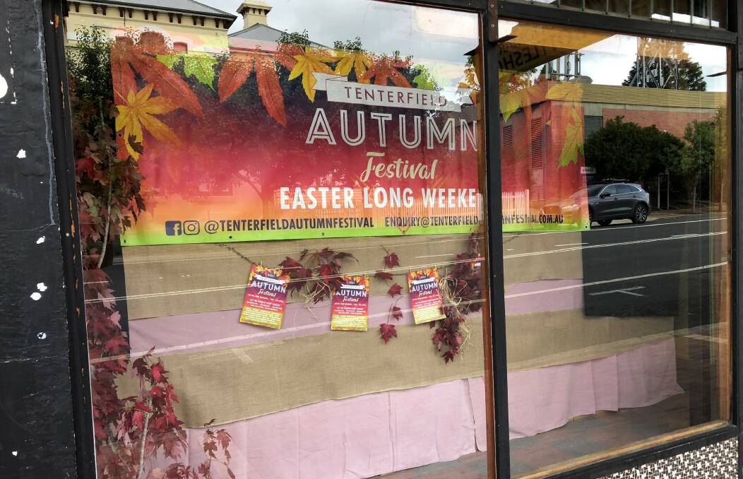 Autumn Festival committee members got busy on the weekend decorating the empty Celebrations Bottle Shop window, and have more empty shops in their sights.