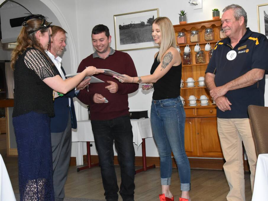 Club president Skye Stapleton and district governor Terry Brown present Cameron Bolton and Paris Haselsberger with their memberships, as sponsor Harry Bolton looks on.