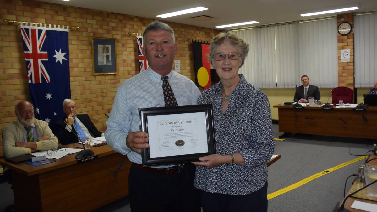 Past-councillor is presented with a certificate of appreciation by mayor Peter Petty.