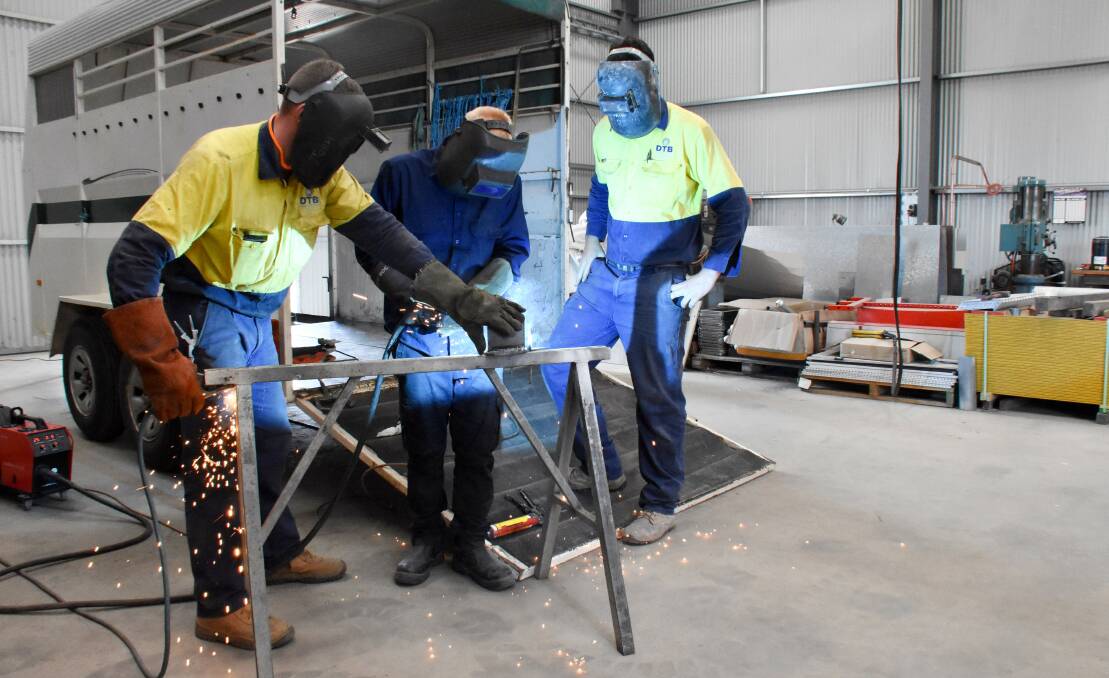 Year 10 student Dominic Clarke gets in some welding practice at DTB Fabrications during work experience week, as DTB's Josh King and Jayson Murphy keep a close eye.