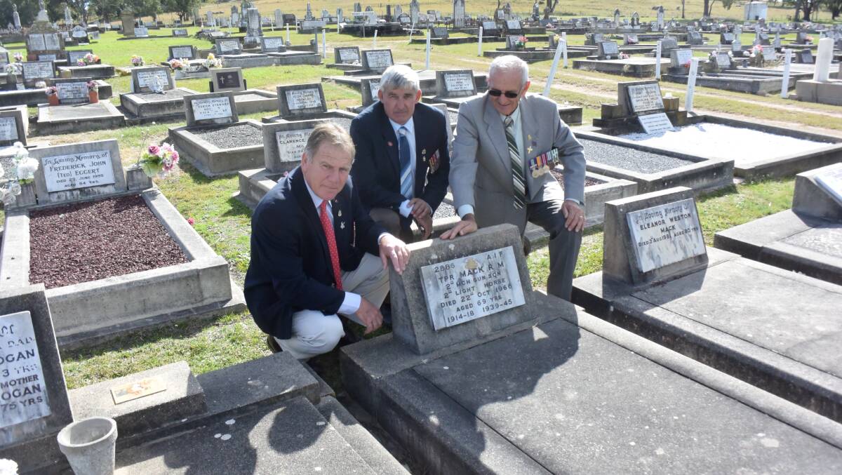 Tenterfield RSL Sub-branch members David Stewart, Ray Holmes and Perry Condrick in Tenterfield Cemetery at the grave of a serviceman.