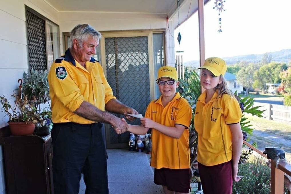 Homestead RFS captain Robert Hines happily received the donation from Oracles' Archie and Rissie George.