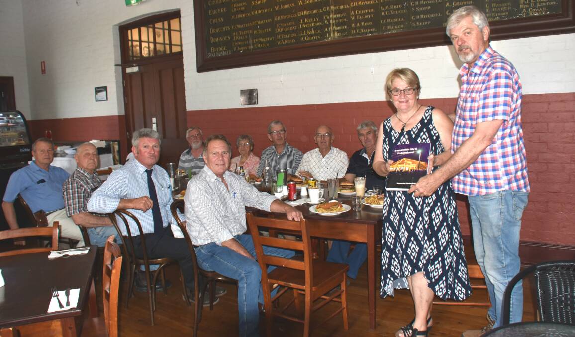 Tenterfield Shire Council ANZAC Centenary Steering Committee chair Peter Reid presents researcher Jan Friar with a copy of 'Sometime We'll Understand' endorsed by all the committee members.