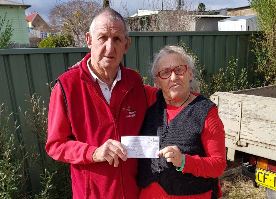 Tenterfield Showground's Bev Harris presents Westpac Life Saver Helicopter Support Group president Dodge Landers with the donation.