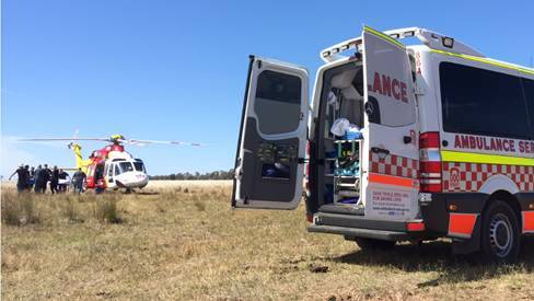 NSW Ambulance paramedics and the NSW Ambulance and Westpac Rescue Helicopter crew work to treat a man who was gored by a bull at Narrabri on Saturday.