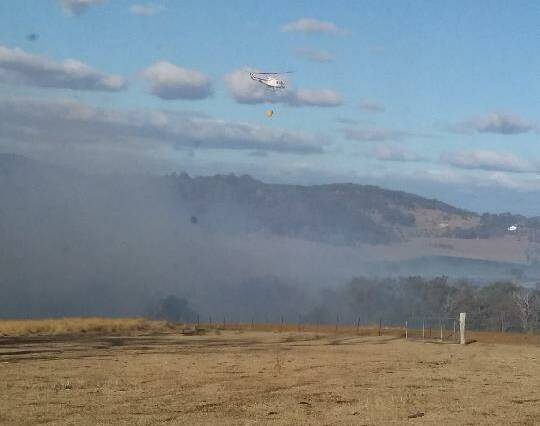 With everyone on tenterhooks, the sight of smoke on Scrub Road brought landholders running with their own firefighting equipment. Fortunately RFS airborne firefighters were also still in the district. Photo by Vicky Little.
