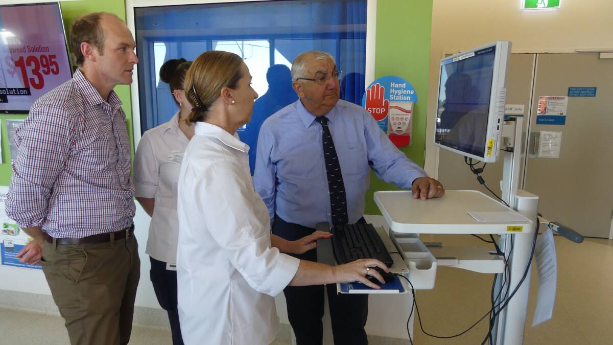 Lismore Base Hospital emergency department customer service manager Tracey Barker demonstrates the department's new dashboard information system to Nationals candidate Austin Curtin and MP Thomas George.